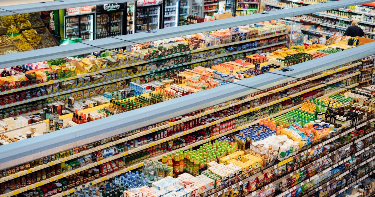 Aerial view of organized grocery store shelves representing industry regulation