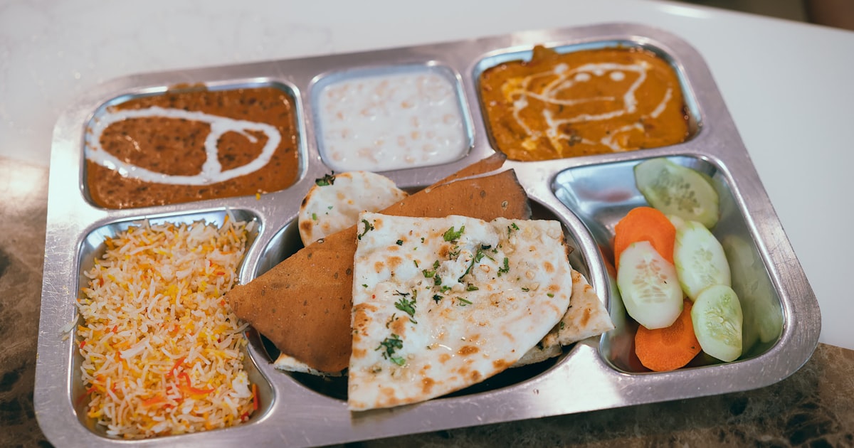 A metal school cafeteria tray filled with food, representing school meal programs for Canadian kids